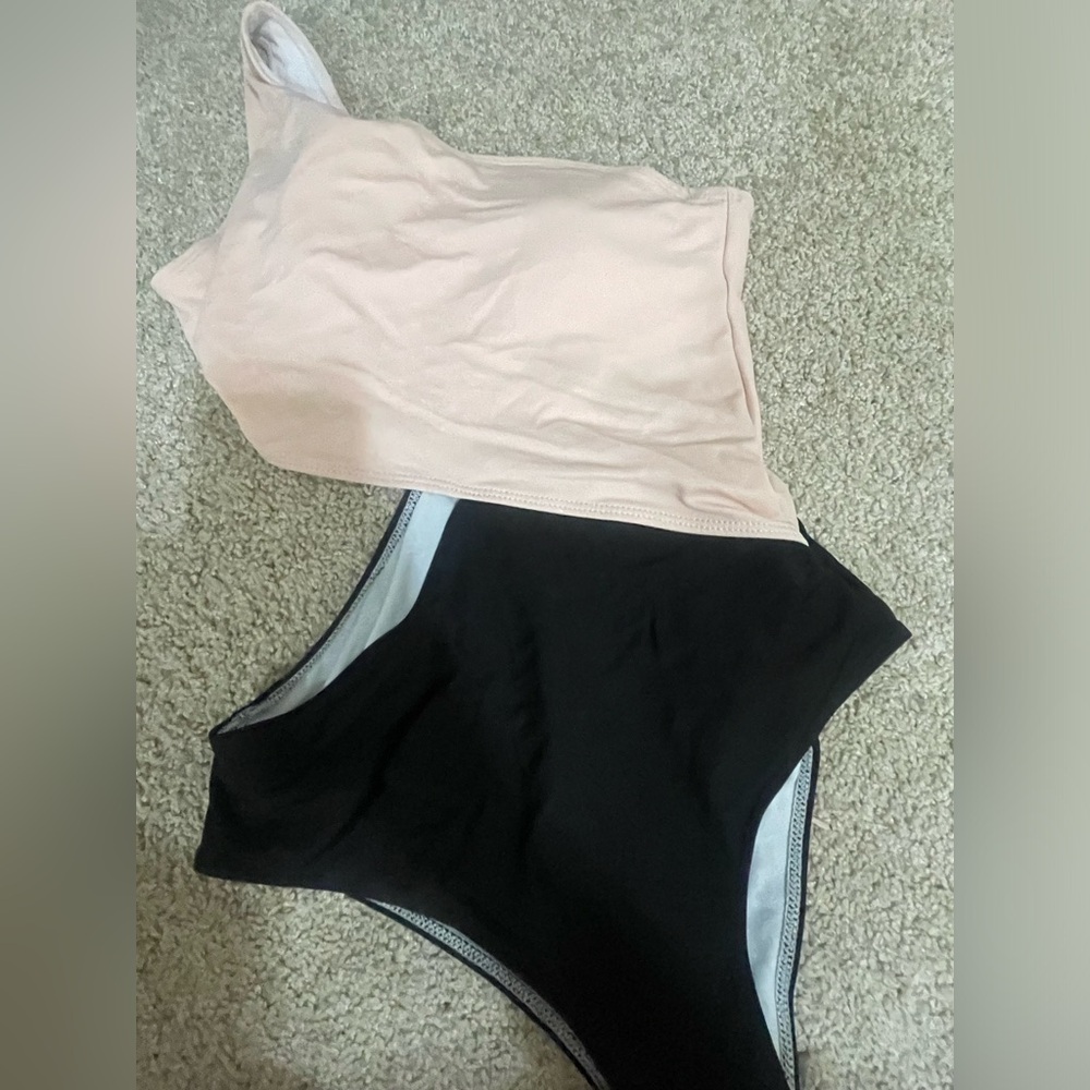2 swim suits one swim tank top and a one piece swimming suit